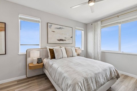 A bedroom with a large bed and a ceiling fan.
