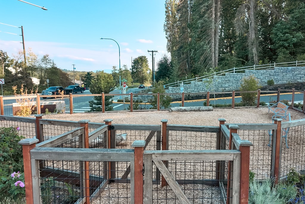 A playground with a wooden structure and a fence.