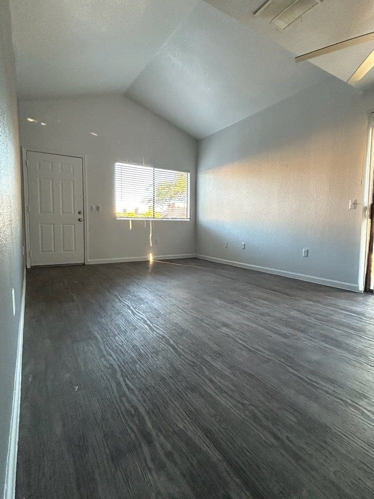 A room with a white door and a window with blinds.