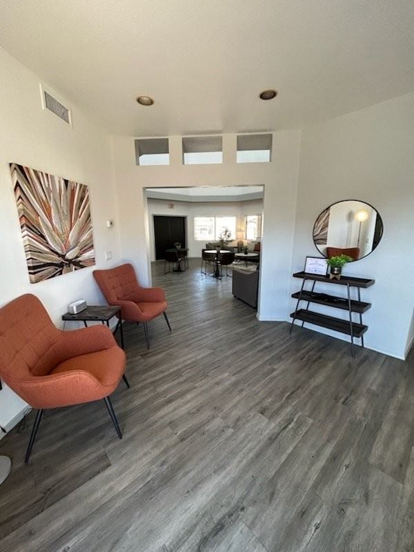 A living room with a grey floor and white walls.