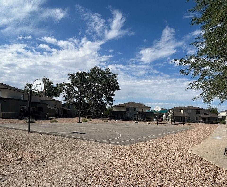 A basketball court with a net and a basketball hoop.
