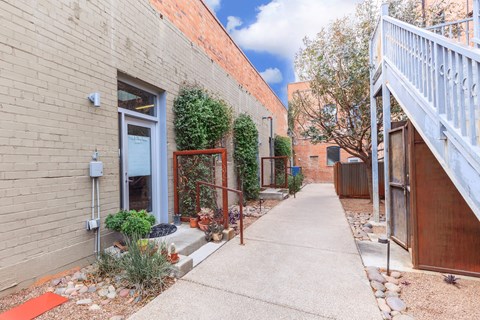 A small alley with a red mat on the ground.
