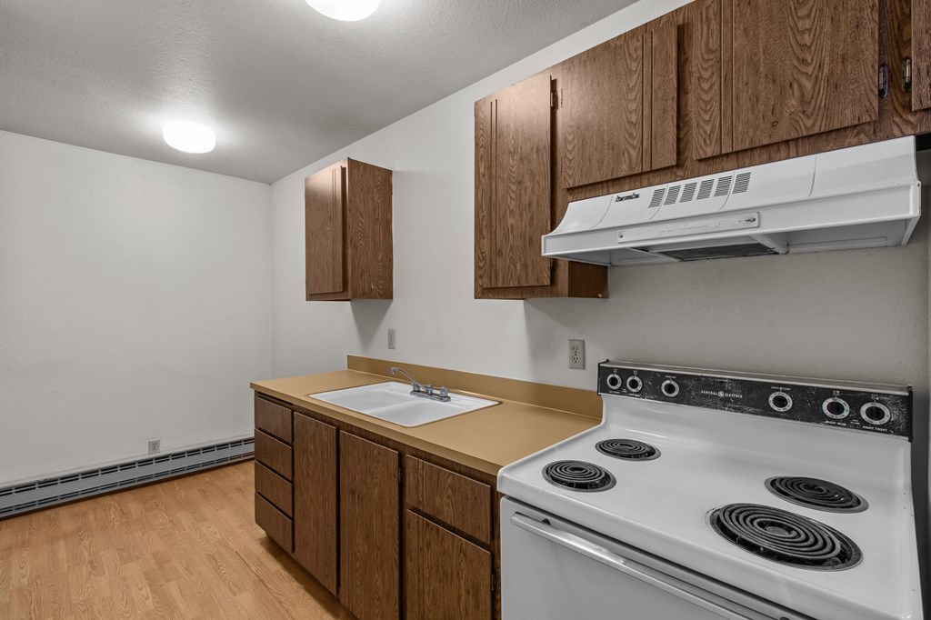 Creekside Apartments an empty kitchen with a stove and a sink
