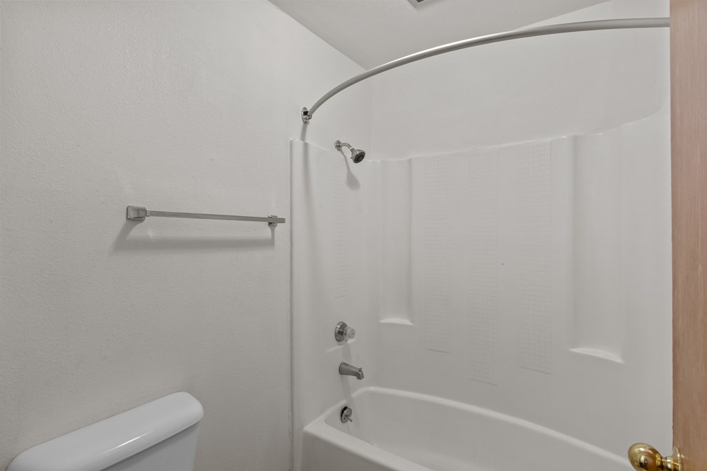 Creekside Apartments a white bathroom with a shower and a toilet