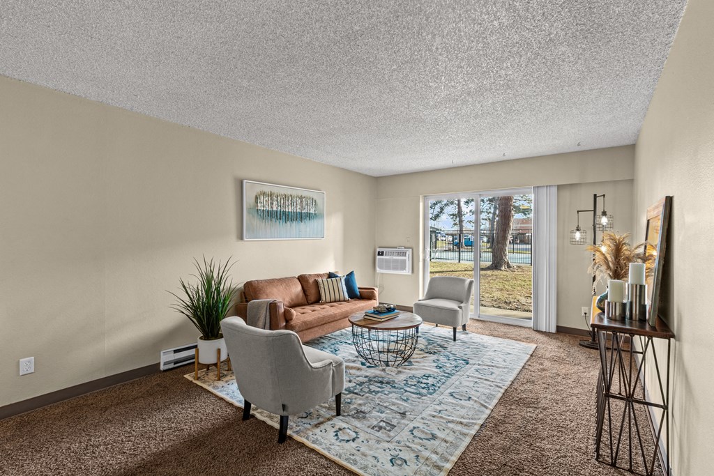 a living room with a couch and chairs and a rug