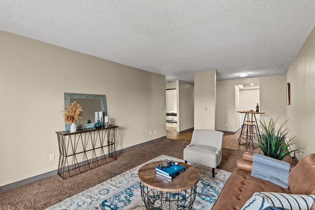 a living room with a couch and a chair and a table