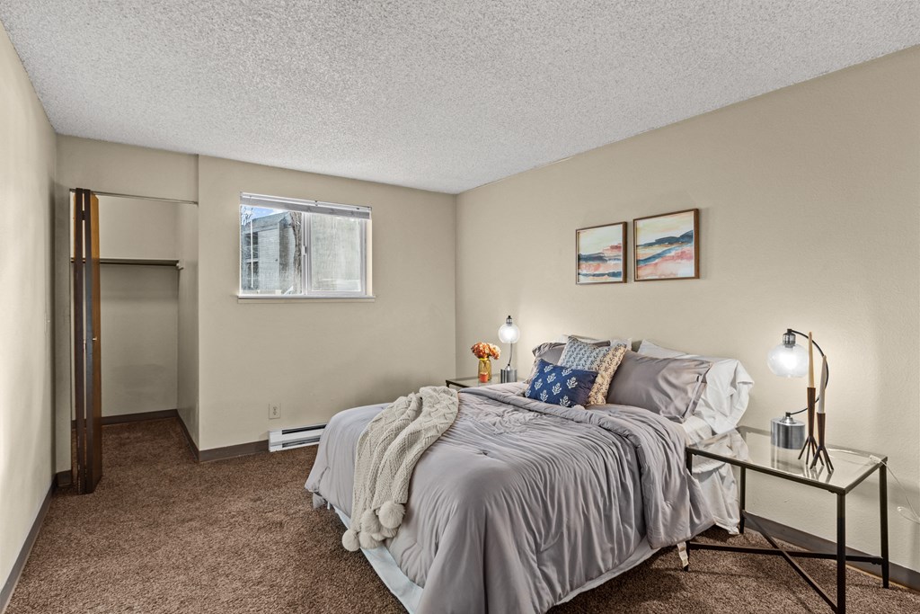 a bedroom with a large bed and a glass nightstand