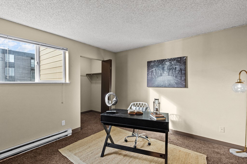 Cedar North Apartments living room with a desk and a window