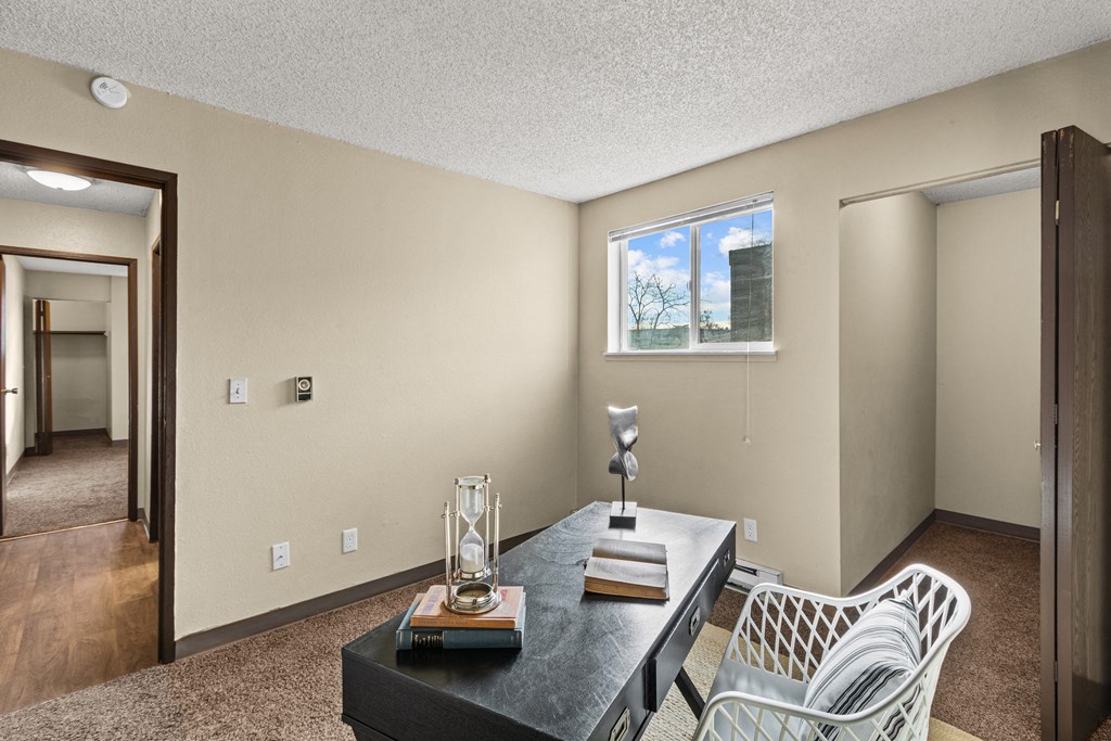 a dining room with a table and chairs and a window