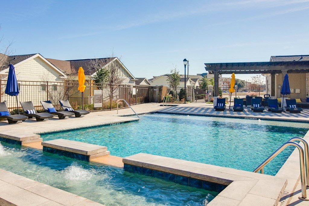 Horizon at Premier Apartments Swimming Pool with Lounge Chairs and Umbrellas.