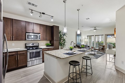 A kitchen with a white counter top and a refrigerator.