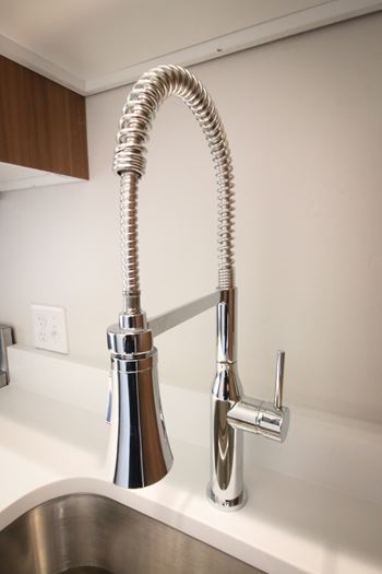 A chrome kitchen faucet with a pull-down sprayer.