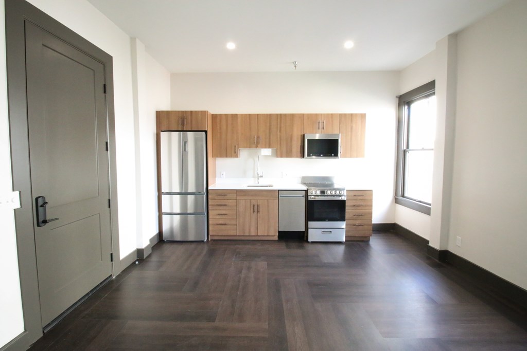 A kitchen with wooden cabinets and stainless steel appliances.