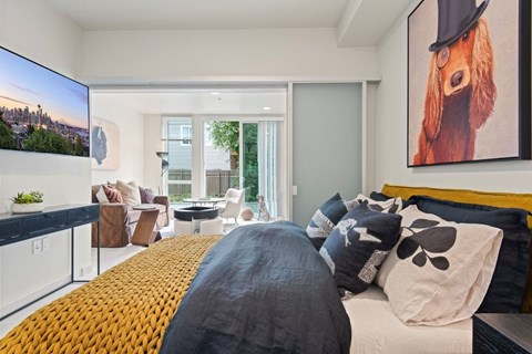 A bedroom with a large bed and a painting of a dog on the wall.