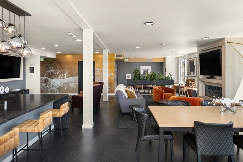 A modern dining room with a long table and chairs.