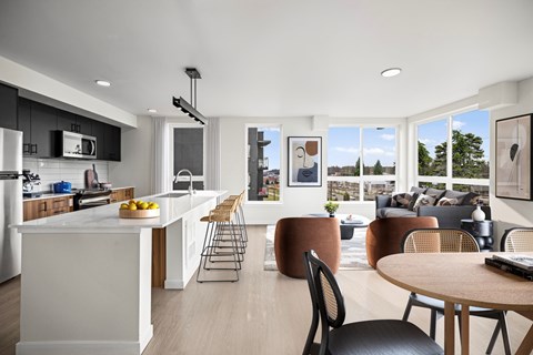 A modern kitchen with a dining table and chairs.