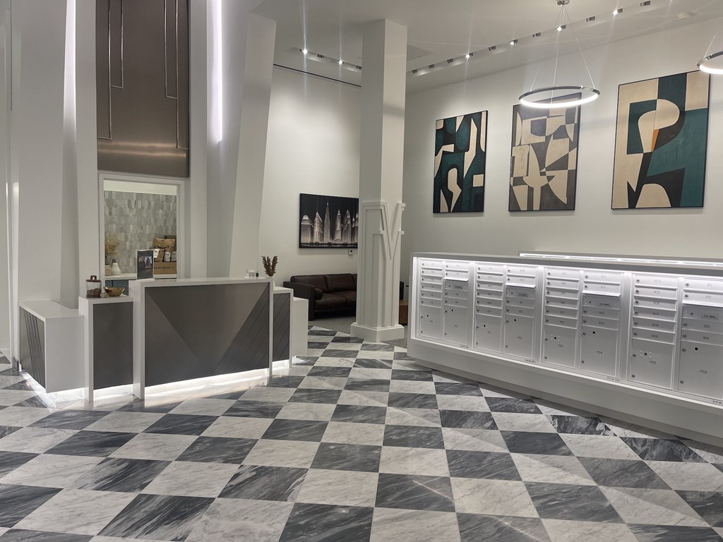 A reception area with a checkered floor and modern art on the wall.