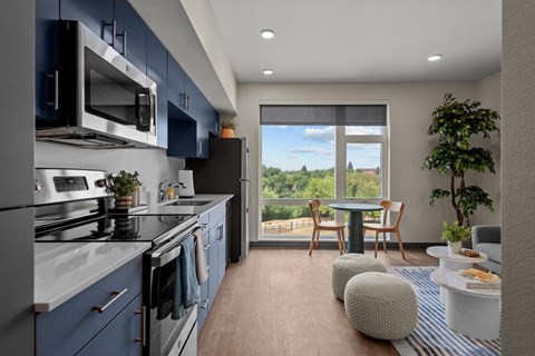 a kitchen with blue cabinets and a window with a view