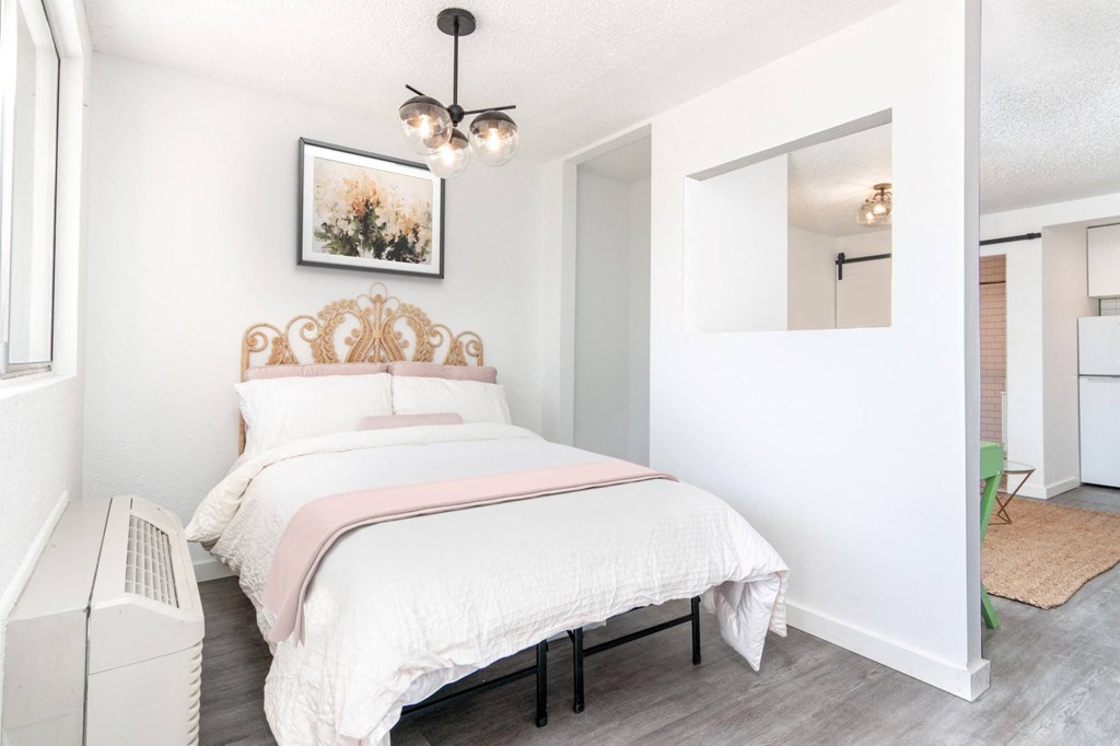 a bedroom with a bed and a mirror