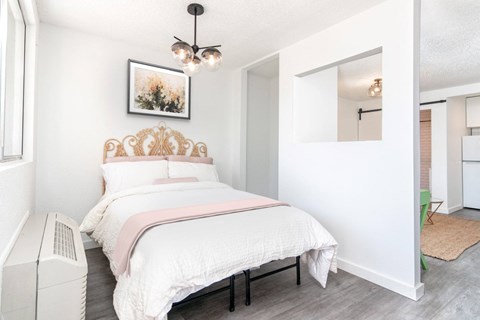 a bedroom with a bed and a mirror