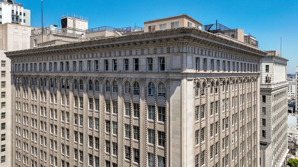 a tall building with many windows and a blue sky in the background