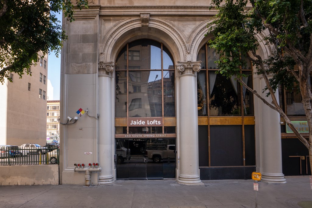 the front of a building with a glass door and an arched doorway
