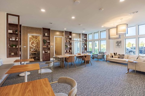 A spacious room with a long table and chairs.