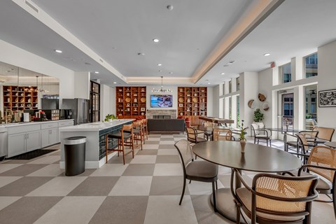 A modern kitchen and dining area with a checkered floor.