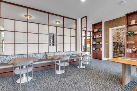 A room with a long wooden table and chairs.