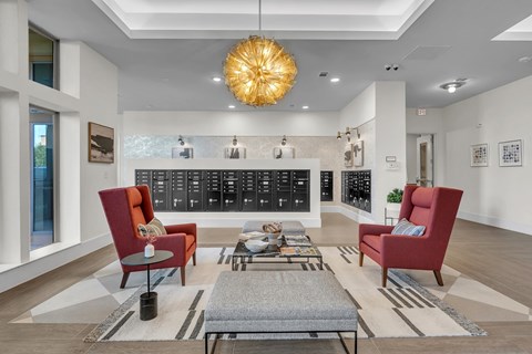 A modern living room with a red chair and a grey coffee table.