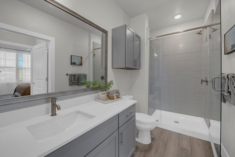 A bathroom with a white sink and a white toilet.
