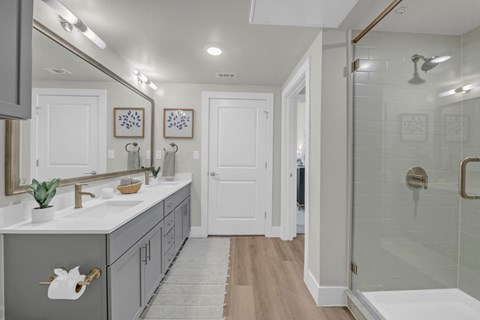 A bathroom with a white door and a white sink.