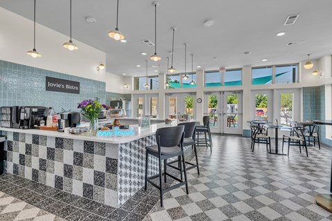 A restaurant with a black and white checkered floor and a counter with a sign that says Iovie's Bistro.