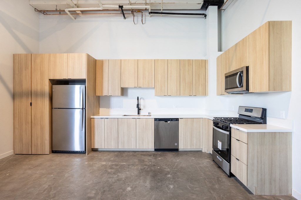 Santa Fe Art Colony kitchen with wooden cabinets and stainless steel appliances