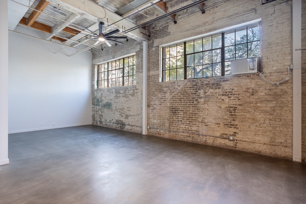 Santa Fe Art Colony room with a brick wall and a large window