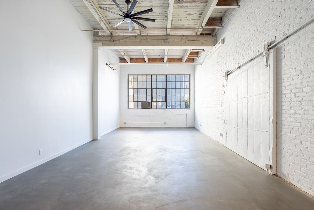 Santa Fe Art Colony room with white walls and a white door and a ceiling fan