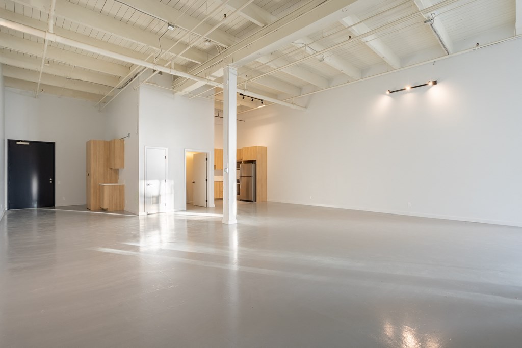 Santa Fe Art Colony room with white walls and wood furniture