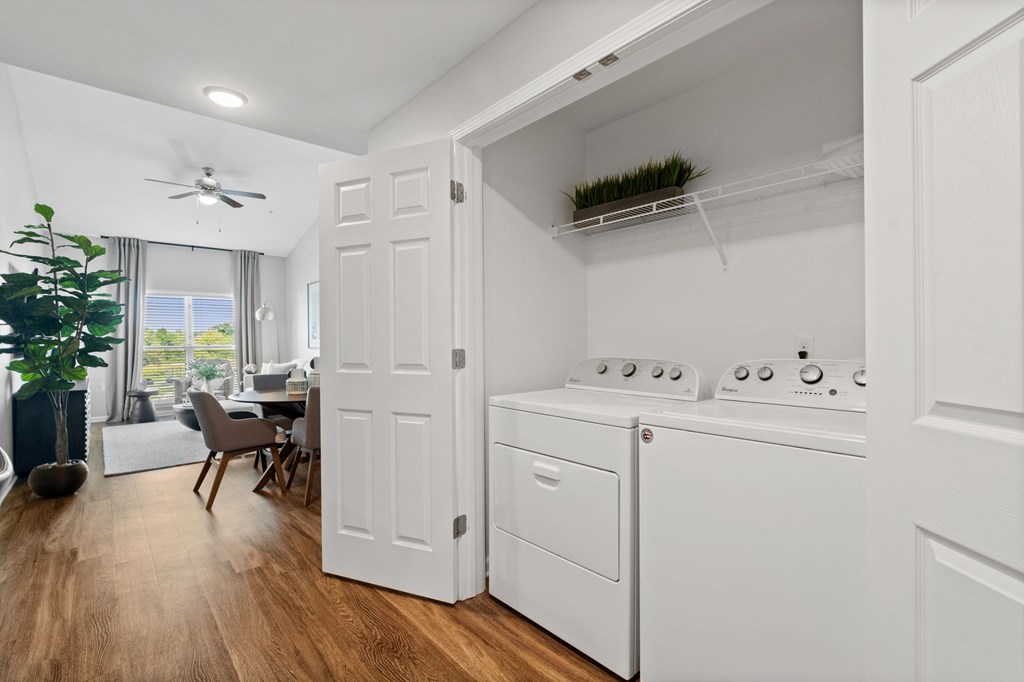 A white laundry room with a washer and dryer.