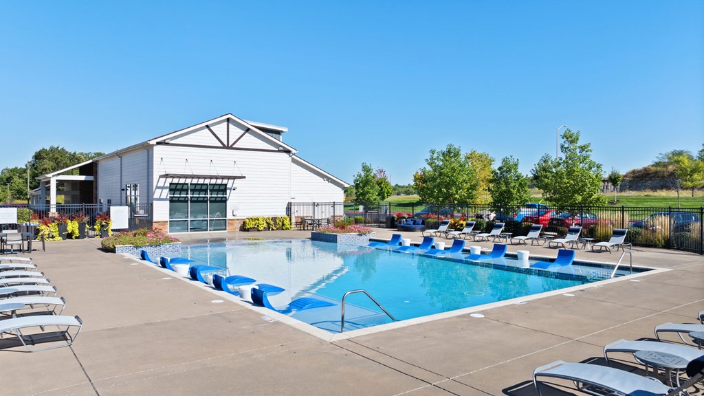 A large white building with a pool in front.