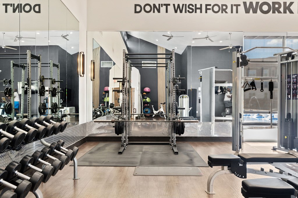 A gym with a sign that says "Don't wish for it, work for it."