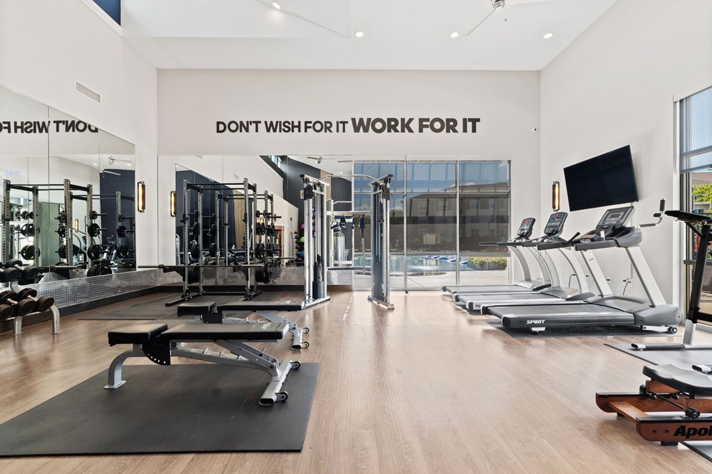 A gym with a sign that says "Don't wish for it, work for it".