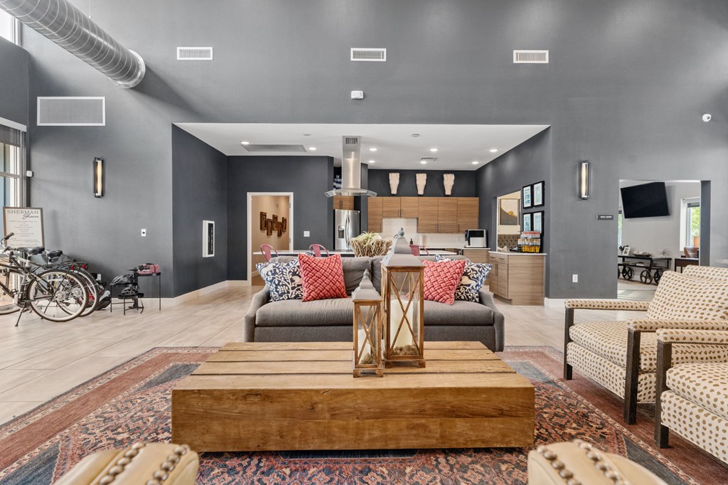 A modern living room with a grey couch and a wooden coffee table.