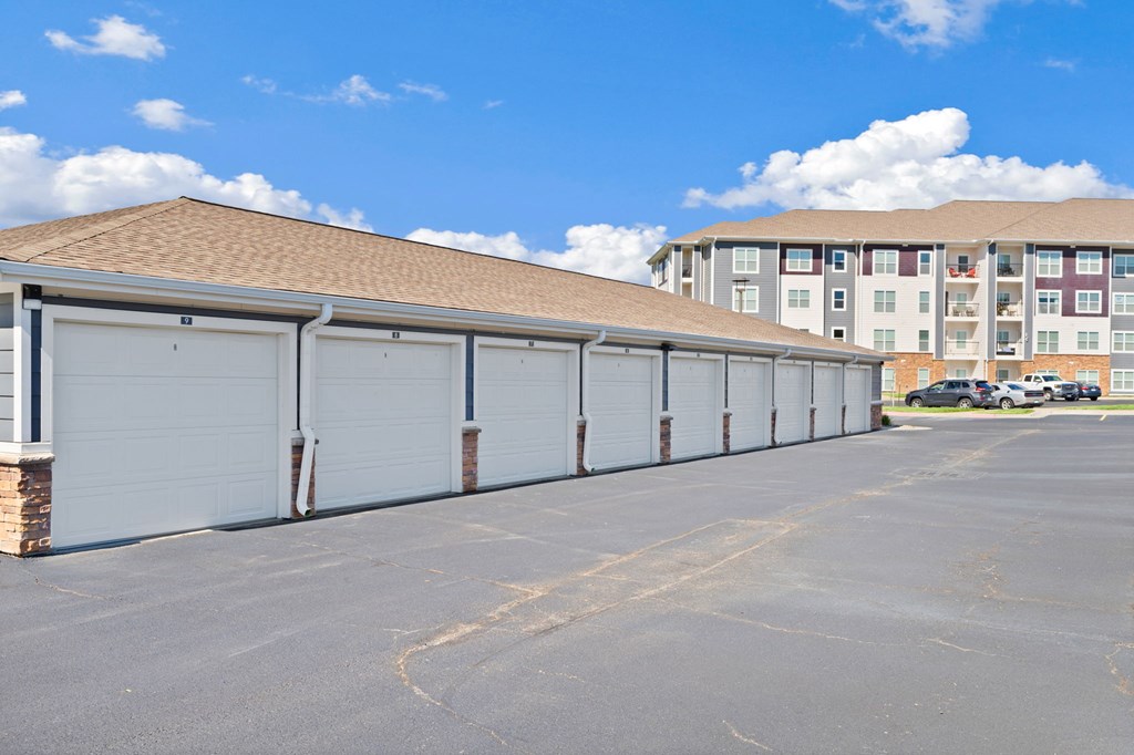 A row of garage doors in front of a building.
