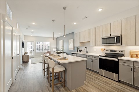 A modern kitchen with a dining area and a refrigerator.