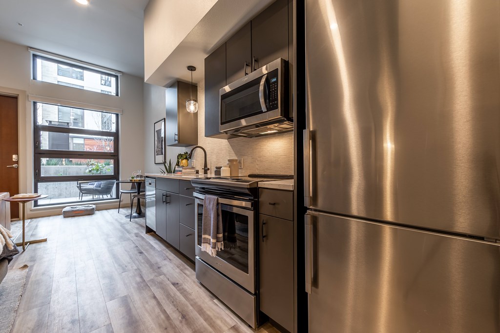 A modern kitchen with a stainless steel refrigerator.