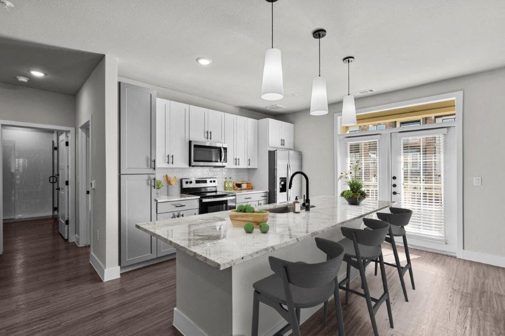 an open kitchen with a marble counter top at Lenox Grand, Austin Texas