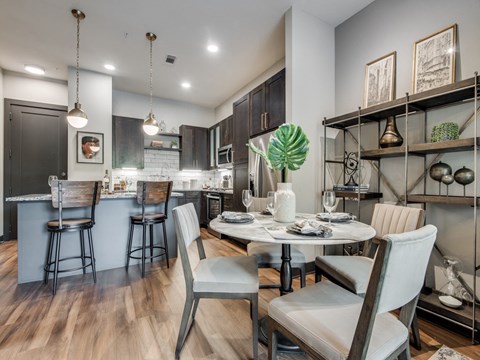a dining room and kitchen with a table and chairs