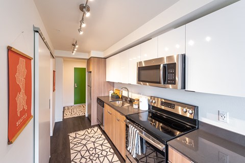 a kitchen with stainless steel appliances and a stove and a microwave