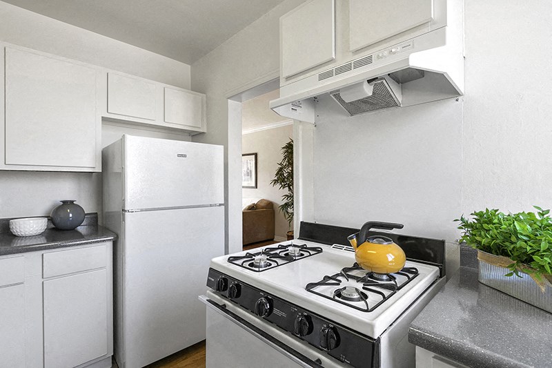 a kitchen with white appliances and a white refrigerator