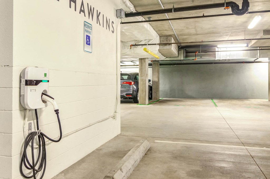 a car is parked in a parking garage next to a white wall